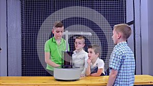 Boys makes experiment with electromagnetic fountain and metal ring