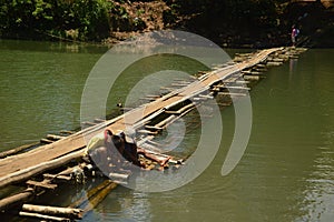 Boys on a makeshift floating bridge
