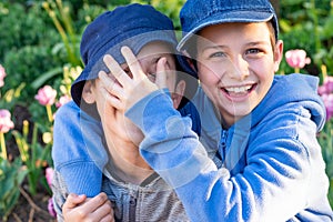 Boys play fighting in the garden