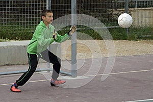 Boys play football in the schoolyard