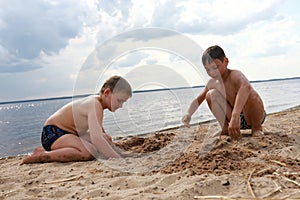 Boys play on sandy beach of Lake Seliger