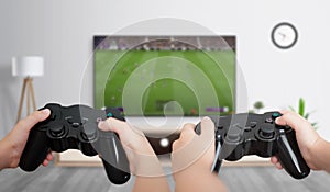 Boys play soccer on the gaming console on a large TV in the room