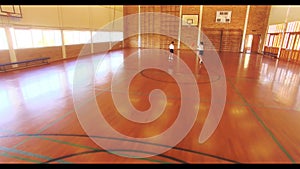 Boys playing basketball in court