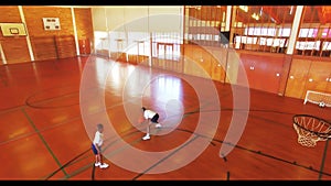 Boys playing basketball in court