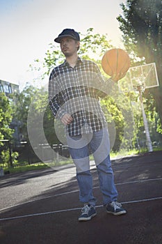 Boys playing basketball outdoors on a sports field