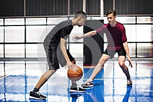 Boys playing basketball together on the court