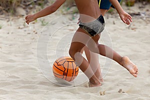 Boys playing beach soccer