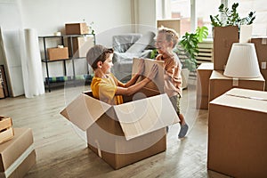 Boys Playing with Boxes in New Home