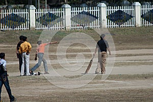 Boys playing criket in the town of Umaria.