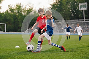 Boys playing a football game in a school tournament. Football soccer match for children