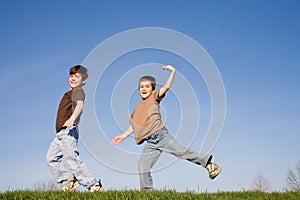 Boys Playing on a Hill