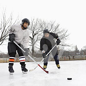 Boys playing ice hockey.