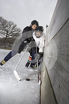 Boys playing ice hockey.