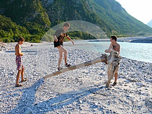 Boys playing near Fella river, Northeast Italy photo