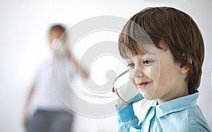 Boys Playing with Tin Can Phone. Isolated on gray Background