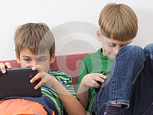 Boys playing video games on tablet computers