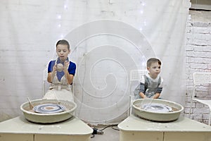 Boys at pottery wheel