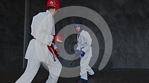 Boys practice fight attack in mix combat style. Young future winners learning martial skills indoor. Dangerous traumatic