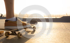 Boys practicing skateboarding during the sunset