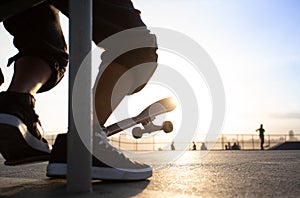 Boys practicing skateboarding during the sunset