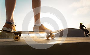 Boys practicing skateboarding during the sunset