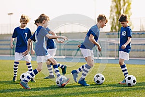 Boys Practicing Soccer on School Field. 10 Years Old Kids on Football Training Class