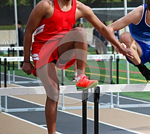 Boys running during a hurdle race on a track