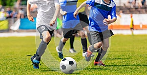 Boys running and kicking soccer ball. Close up action of boys soccer teams, aged 8-10