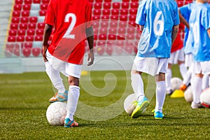 Boys soccer team training. Soccer football players training. Kids playing soccer on a stadium field