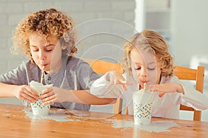 Boys spilling milk