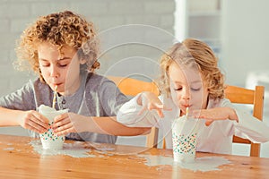 Boys spilling milk photo