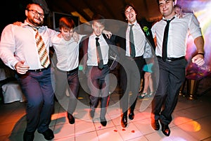 Boys in suits dance on the disco