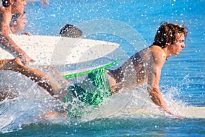 Boys surfers surfing running jumping on surfboards