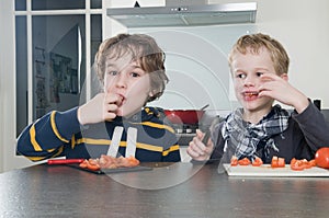 Boys tasting tomato