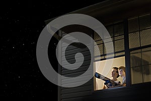 Boys With Telescope Looking At Night Sky