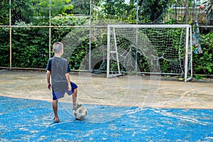 The boys are about to shoot football On the pitch.