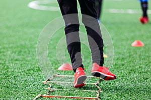 Boys in white white sportswear running on soccer field. Young footballers dribble . Training, active lifestyle, sport