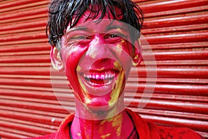 A boyâ€™s face smeared with colour.