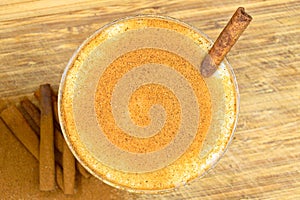 Boza and cinnamon sticks, traditional Turkish cuisine drinks, on wooden background