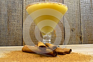 Boza and cinnamon sticks, traditional Turkish cuisine drinks, on wooden background