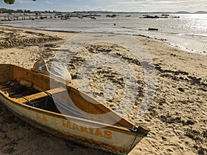 Bozius beach with an old wooden boat in Rio de Janeiro State