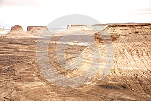 Bozzhyra tract in Kazakhstan, a scenic and arid desert landscape featuring dramatic rock formations and sediment layers