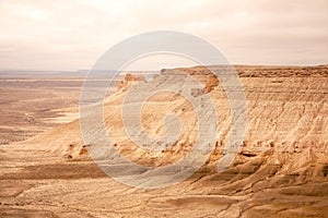 Bozzhyra tract in Kazakhstan, a scenic and arid desert landscape featuring dramatic rock formations and sediment layers