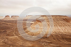 Bozzhyra tract in Kazakhstan, a scenic and arid desert landscape featuring dramatic rock formations and sediment layers