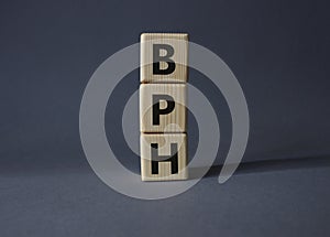 BPH - Benign Prostatic Hyperplasia symbol. Wooden cubes with word BPH. Beautiful grey background. Medical and BPH concept. Copy