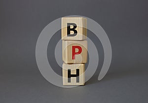 BPH - Benign Prostatic Hyperplasia symbol. Wooden cubes with word BPH. Beautiful grey background. Medical and BPH concept. Copy