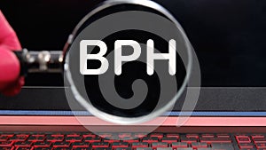 BPH Benign Prostatic Hyperplasia text on the monitor found through a magnifying glass