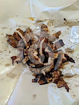 BPK, Babi Panggang Karo, pieces of grilled pork on paper packaging