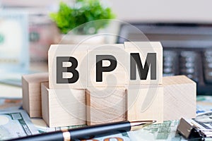 Bpm concept with wooden blocks on table, business concept