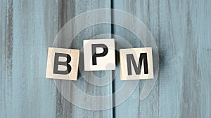 BPM made with wooden blocks on light background